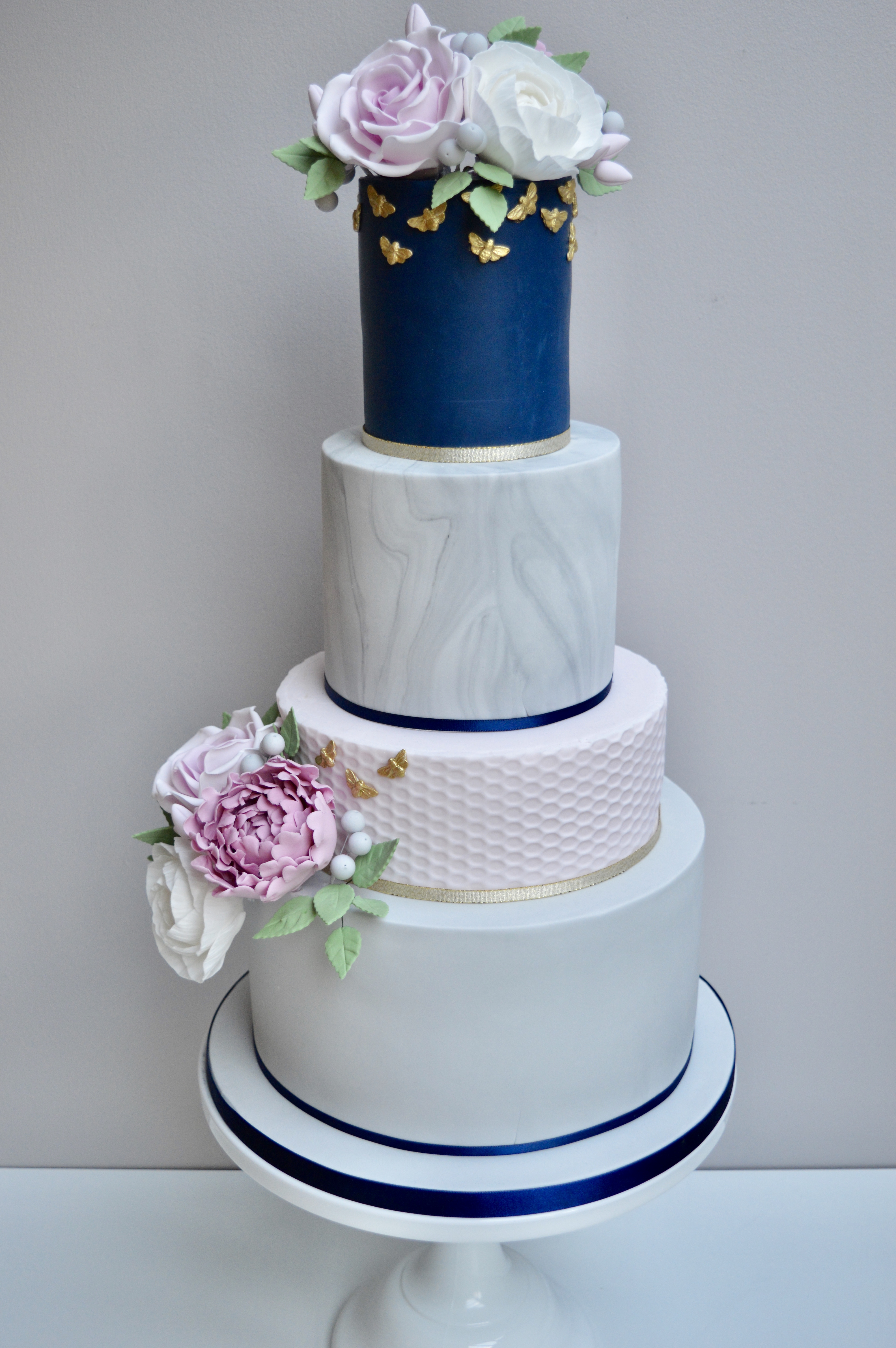 Wonderful 4 tier wedding cake with roses and peonies